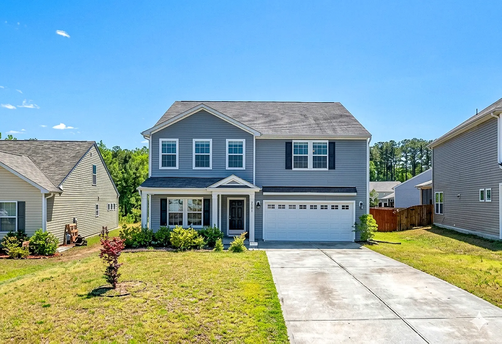 Gray Two Story With Attached Garage Wide Crop Pic